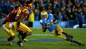 UCLA running back Paul Perkins (24) runs for yardage against Southern California in the first half of a NCAA college football game at the Rose Bowl in Pasadena, Calif., Saturday, Nov. 22, 2014. (Photo by Keith Birmingham/ Pasadena Star-News)